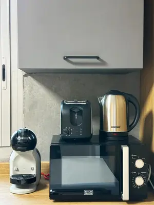 a microwave with a coffee maker and a toaster at Ultra Luxury Flat Fully Upgrade with Balcony in Marina in Dubai