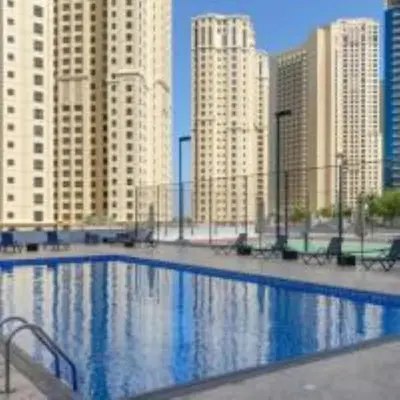 a large swimming pool in a city with tall buildings at Best Spot in Marina Dubai in Dubai