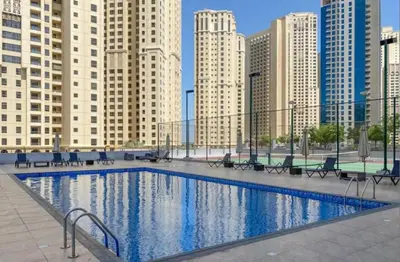 a large swimming pool in a city with tall buildings at Best Spot in Marina Dubai in Dubai