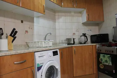 a kitchen with a washing machine in a kitchen at Newly furnished 1 Bedroom, high floor, amazing view, close to metro in Dubai