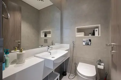 a bathroom with a white sink and a toilet at Full Lagoon View Beach Access Exclusive building in Dubai