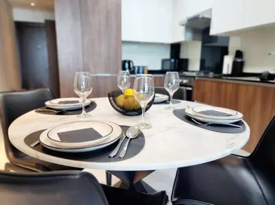a table with plates and wine glasses on it at Alaia Retreat in Dubai