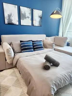 a large bed in a living room with a couch at Alaia Retreat in Dubai