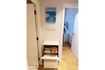a hallway with a white cabinet with oranges on it at Full Seaview Comfortable Apt La Mer Dubai in Dubai