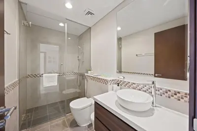 a bathroom with a sink and a toilet and a shower at Burj khalifa and Canal views - Luxury Apartments for Rent in Dubai Business Bay in Dubai