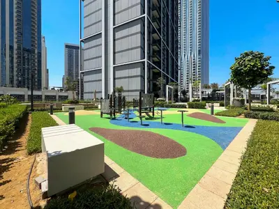 a park with a playground in front of a building at Elegant 1 bedroom in Creek Edge in Dubai