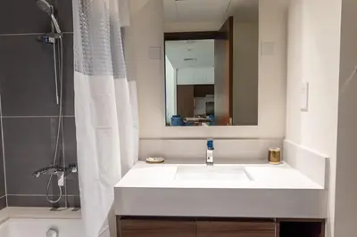 a bathroom with a white sink and a mirror at Elegant 1 bedroom in Creek Edge in Dubai