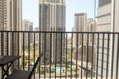 a balcony with a view of a city with tall buildings at Elegant 1 bedroom in Creek Edge in Dubai
