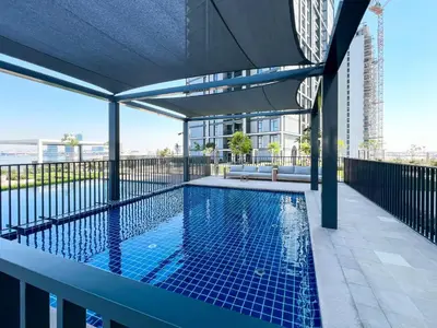 a swimming pool on the roof of a building at Elegant 1 bedroom in Creek Edge in Dubai