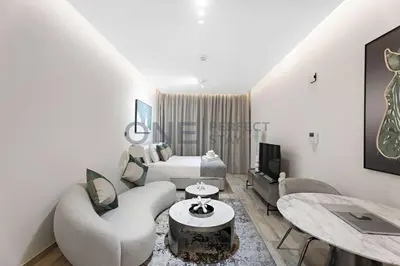 a living room with a couch and a table at Studio Chic In Business Bay With Pool and Gym in Dubai