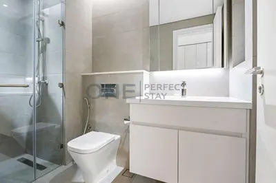 a bathroom with a toilet and a sink and a shower at Studio Chic In Business Bay With Pool and Gym in Dubai