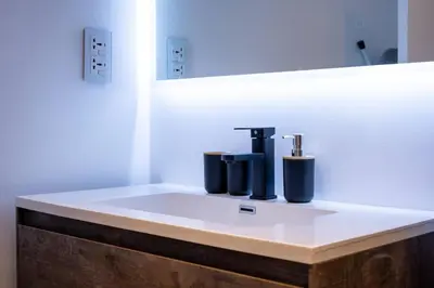 a bathroom with a sink with a faucet at Spacious Luxe Studio Near Metro in Dubai
