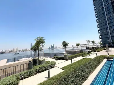 a swimming pool with a view of the water at Elegant 1 bedroom in Creek Edge in Dubai