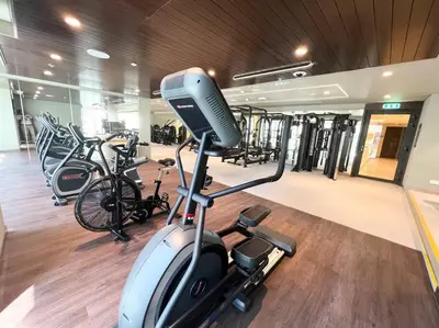 a gym with a treadmill and bikes in it at Elegant 1 bedroom in Creek Edge in Dubai