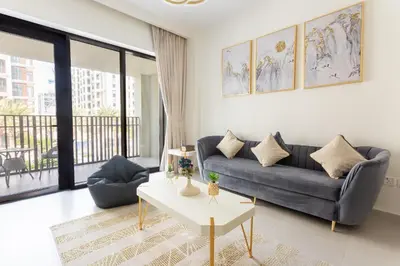 a living room with a couch and a table at Elegant at Creek Beach 1 BHK in Dubai