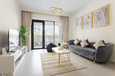 a living room with a couch and a tv at Elegant at Creek Beach 1 BHK in Dubai