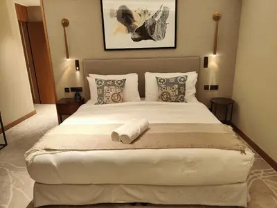 a bedroom with a large white bed with two pillows at 2BD Luxury Opera District Apt Downtown in Dubai
