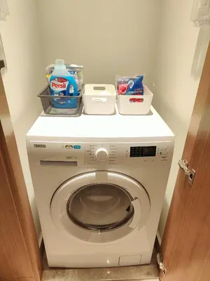 a washing machine with a shelf on top of it at 2BD Luxury Opera District Apt Downtown in Dubai