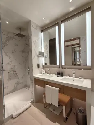 a bathroom with two sinks and a shower at 2BD Luxury Opera District Apt Downtown in Dubai