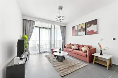 a living room with a couch and a table at Stylish 1 Bedroom High Floor in Creek Edge in Dubai