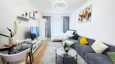 a living room with a couch and a tv at Dubai Marina - Modern Design Studio Apartment, Marina Diamond 2 in Dubai