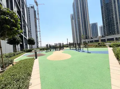 a golf course in the middle of a city with tall buildings at Stylish 1 Bedroom High Floor in Creek edge in Dubai