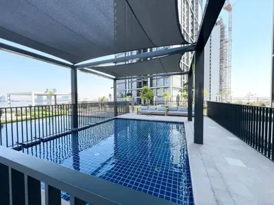 a swimming pool on the balcony of a building at Stylish 1 Bedroom High Floor in Creek edge in Dubai