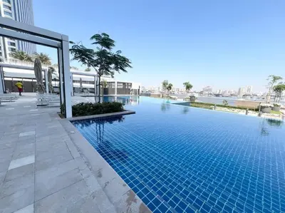 a large swimming pool in a building at Stylish 1 Bedroom High Floor in Creek edge in Dubai