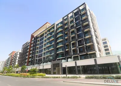 a large building on a street next to a road at Alluring Studio Apartment at Azizi Riviera 16, Al Merkadh by Deluxe Holiday Homes in Dubai