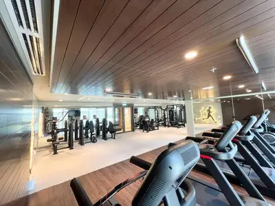 a gym with treadmills and cardio equipment in a building at Stylish 1 Bedroom High Floor in Creek Edge in Dubai