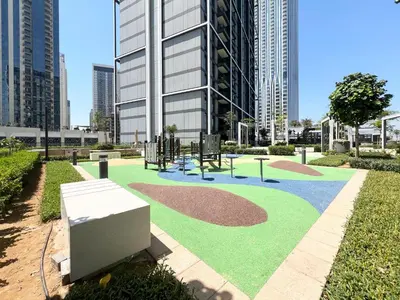 a park with a playground in front of a building at Elegant 1 bedroom in Creek Edge in Dubai