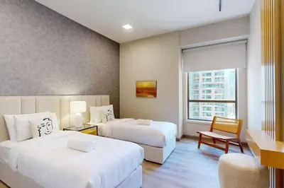 a hotel room with two beds and a window at Rimal 1 - Opulant Two Bedroom in Dubai