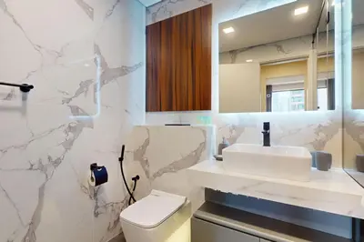 a bathroom with a sink and a toilet and a mirror at Rimal 1 - Opulant Two Bedroom in Dubai