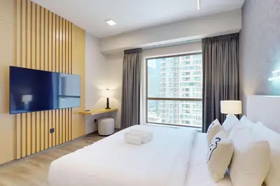 a hotel room with a large bed and a large window at Rimal 1 - Opulant Two Bedroom in Dubai