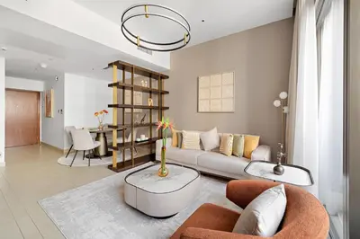 a living room with a couch and a table at Chic 1-Bed Near Marina Promenade - 5 min to Tram in Dubai