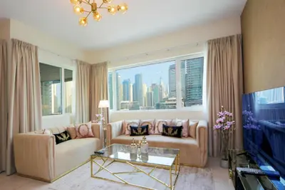 a living room with a couch and a large window at Stunning Marina view apartment In Marina sail tower by Truebleu vacation homes in Dubai