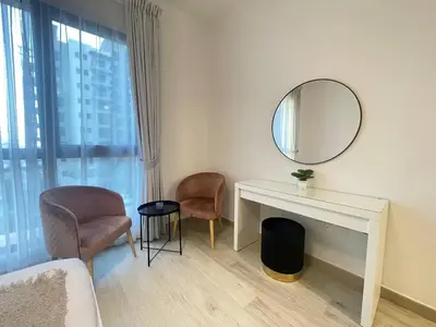 a white room with a desk and a mirror at Luxe & Comfy Madinat Jumeirah - Apartment with Scenic Views - Pool Managed by SunnyHomes in Dubai