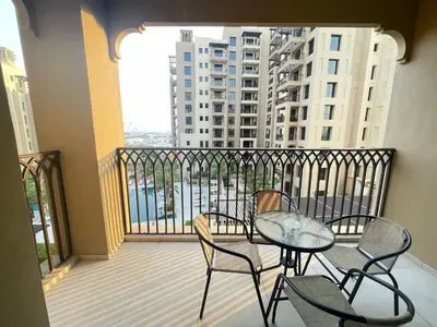 a balcony with a table and chairs on a balcony at Luxe & Comfy Madinat Jumeirah - Apartment with Scenic Views - Pool Managed by SunnyHomes in Dubai