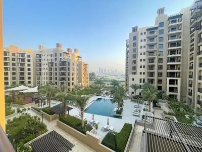 a view of a pool in a city with tall buildings at Luxe & Comfy Madinat Jumeirah - Apartment with Scenic Views - Pool Managed by SunnyHomes in Dubai