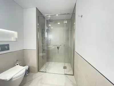 a bathroom with a shower and a toilet at Luxe & Comfy Madinat Jumeirah - Apartment with Scenic Views - Pool Managed by SunnyHomes in Dubai