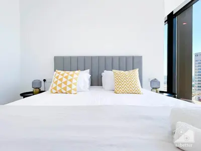 a bedroom with a large white bed with two pillows at Stylish One-Bedroom Getaway in Business Bay in Dubai