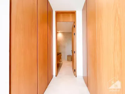 a hallway with wooden doors and a hallway leading into a room at Stylish One-Bedroom Getaway in Business Bay in Dubai