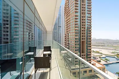 a balcony with chairs and a view of buildings at Big 1BD in JLT - Pool, Game Zone in Dubai