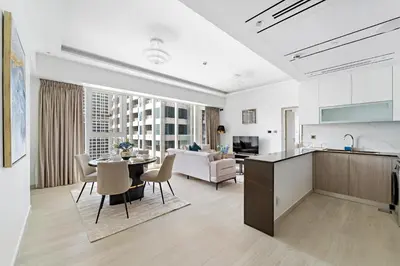 a kitchen and living room with a table and a couch at Big 1BD in JLT - Pool, Game Zone in Dubai