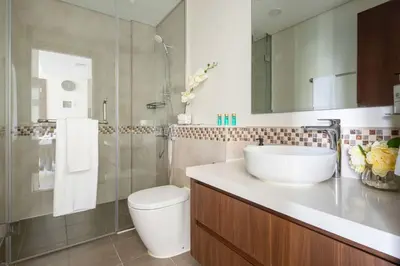 a bathroom with a sink and a toilet and a shower at Frank Porter - Vera Residences in Dubai