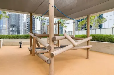 a wooden swing in a building with buildings in the background at Frank Porter - Vera Residences in Dubai