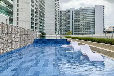 a swimming pool on the roof of a building with buildings at Frank Porter - Vera Residences in Dubai