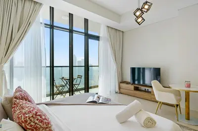 a bedroom with a bed and a large window at Stylish Studio with Great Views High Floor in Dubai