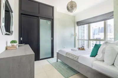 a bedroom with a large bed and a window at Frank Porter - Al Majara Tower 2 in Dubai