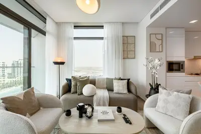 a living room with a couch and chairs and a table at Palace Residence, Dubai Creek Harbour - Mint Stay in Dubai